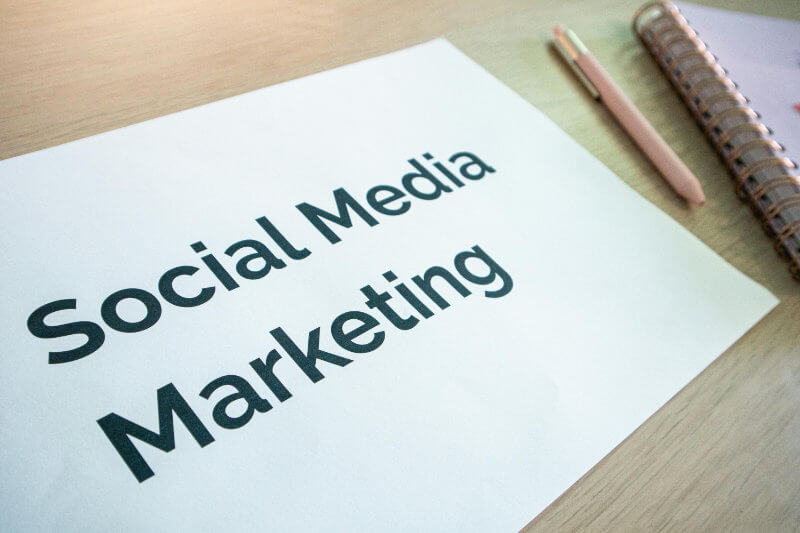 Social Media Marketing Services written on a white piece of paper on a desk